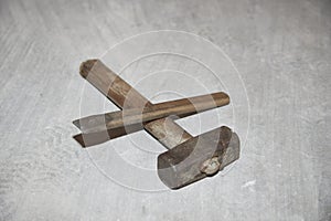 hammer and chisel on the ground of a construction site as a background