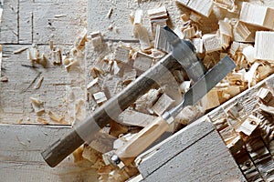 Hammer and chisel lie on the boards