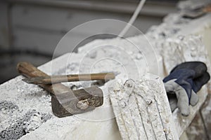 hammer and chisel on a wall at a construction site