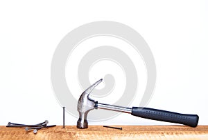 Hammer and construction nails on isolated white background close-up. With place under the text