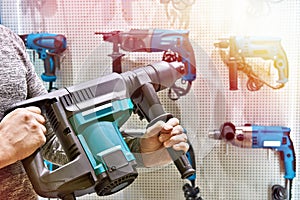 Hammer drill in man`s hands