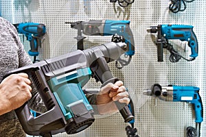 Hammer drill in man`s hands