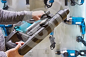 Hammer drill in man`s hands