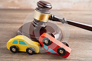 Hammer gavel judge with car vehicle accident, insurance coverage claim lawsuit court case