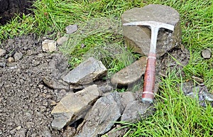 Hammer for a geologist, drill cuttings and a drill core