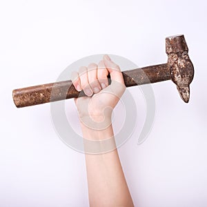 Hammer in the hand of a girl. Symbol of hard work, feminism and labor day. Isolate on white background