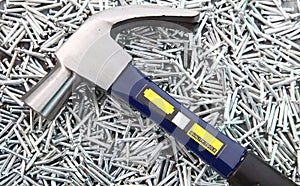 Hammer on heap of Silver nails