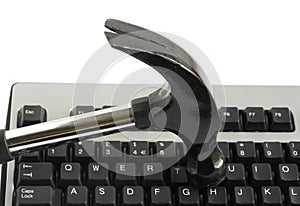 Hammer hitting computer keyboard
