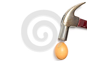 Hammer hitting a cracked egg isolated on white