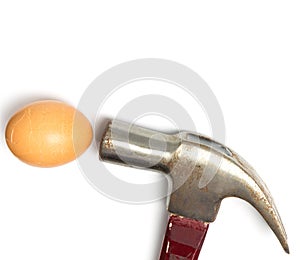 Hammer hitting an egg on white