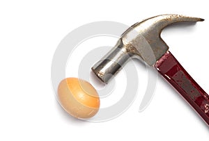 Hammer hitting an egg on white background.