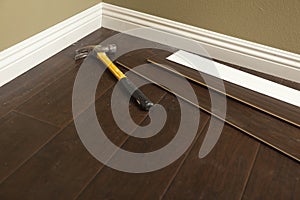 Hammer, Laminate Flooring and New Baseboard Molding