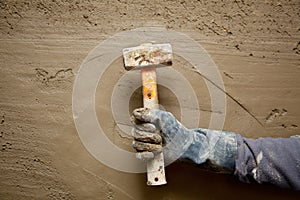Hammer man with gloves in grunge cement background