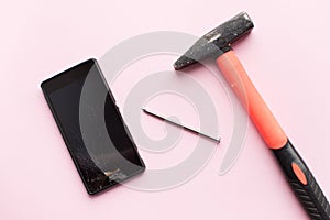 Hammer and mobile phone with broken display