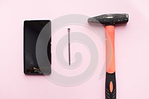 Hammer and mobile phone with broken display