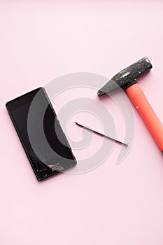 Hammer and mobile phone with broken display