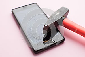 Hammer and mobile phone with broken display