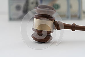 Hammer with money to show a judgment paid with cash