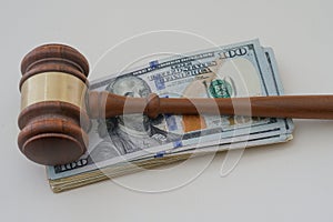 Hammer with money to show a judgment paid with cash