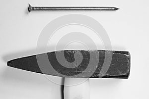 Hammer with a nail isolated on white background