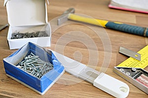 Hammer, nails, stationery knife with blade, screws for assembling furniture