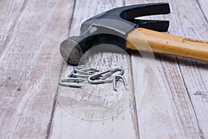 Hammer and nails on wood background