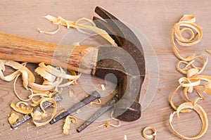 Hammer and nails on a wood board