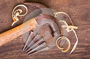 Hammer and nails on a wood board