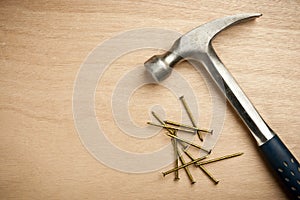 Hammer and nails on wood plank