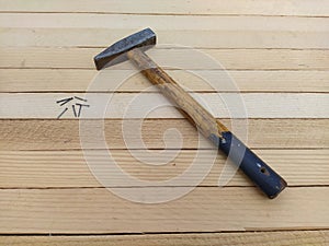 Hammer and nails on a wooden background photo