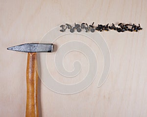 Hammer and nails at wooden background with space for your own text for an invitation for a workshop etc