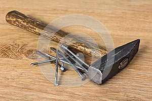 Hammer and nails on a wooden surface