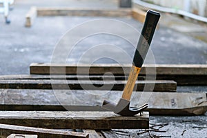 Hammer, rusty nail and wood for carpenter`s job