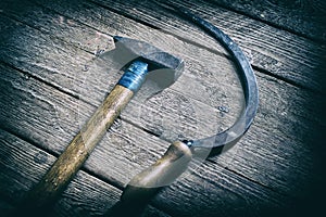 Hammer and sickle lying on wooden board background