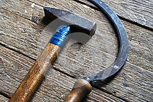 Hammer and sickle lying on wooden board background