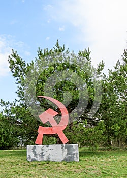 Hammer and sickle monument in park