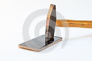 hammer smashes on old mobile phone, broken glass