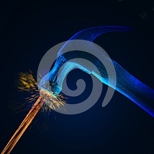 Hammer striking nail w/sparks photo