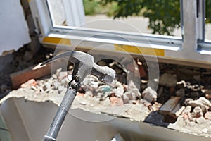 Hammer - a tool for dismantling an old window, installation of a plastic window, repair work