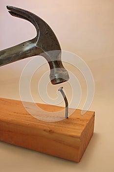 Hammer trying to pound crooked nail