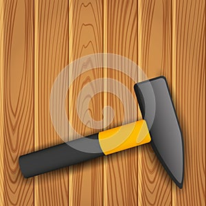 Hammer on wood background.