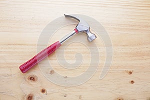 A hammer on a wood table