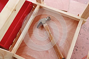 Hammer on wooden background