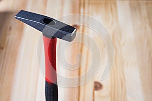 Hammer on wooden background. high quality, beautiful light. space for text and ads. copy space for the label next to it