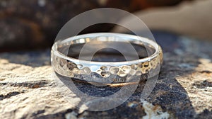 Hammered Silver Band Wedding Ring On Stone