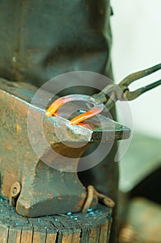 Hammering glowing steel - to strike while the iron is hot.