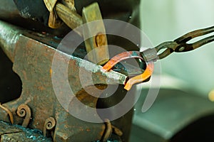 Hammering glowing steel - to strike while the iron is hot.