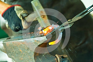 Hammering glowing steel - to strike while the iron is hot.