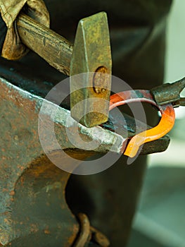 Hammering glowing steel - to strike while the iron is hot.