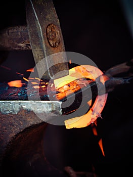 Hammering glowing steel - to strike while the iron is hot.